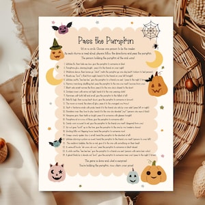 May include: A Halloween-themed game sheet titled "Pass the Pumpkin" with illustrations of pumpkins, bats, and moons. The game instructions are printed on a cream-colored background with a decorative border. The game is designed for Halloween.