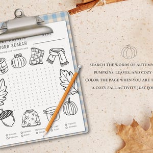May include: A fall-themed word search on a clipboard with a pencil. The page features drawings of autumn items like pumpkins, leaves, and a sweater. Text on the page reads: "Search the words of autumn cheer, pumpkins, leaves, and cozy gear."