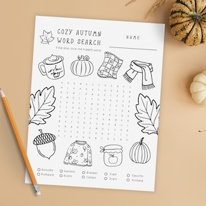Cozy Autumn Word Search printable with pumpkins and gourds on beige background. Printable cozy autumn word search game for kids with fall-themed words like pumpkin, harvest, blanket, and cider. Fun fall classroom activity, homeschool learning worksheet, or family game night printable.