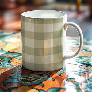 May include: A white ceramic mug with a green and white gingham pattern. The mug has a handle and is sitting on a colorful tiled surface.