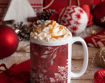 May include: A white ceramic mug with a red and white festive design. The mug is filled with a creamy drink topped with whipped cream and caramel sauce. The mug is surrounded by festive decorations, including red baubles, a white knitted stocking, and a pine cone.
