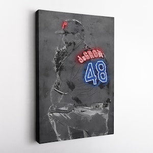May include: A black and white illustration of a baseball player in a pitching stance. The player is wearing a baseball cap, jersey, and pants. The jersey has the name "deGROM" and the number "48" in neon red and blue lettering.