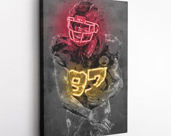 May include: A digital art print of a football player wearing a black and gold uniform with a red neon helmet and a yellow neon number 99 on the front. The background is a grey textured surface.
