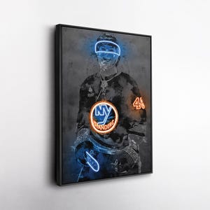 May include: Framed artwork of a hockey player in a neon style. The player is wearing a black jersey with the NY Islanders logo. The artwork uses blue and orange neon outlines to highlight the player and details.