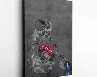 May include: A black and white illustration of a hockey player wearing a Florida Panthers jersey with a red "FLORIDA" logo. The player is in a dynamic pose, with their arm raised and their stick held in their hand. The background is a textured gray surface.