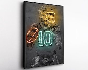 May include: Neon art print of a football player in a green and yellow uniform, holding a football. The number 10 is on the jersey. The artwork has a grunge style with a black frame.