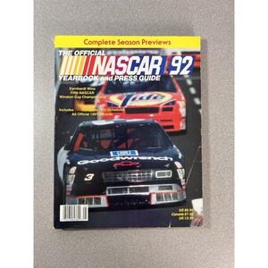 May include: The Official NASCAR 92 Yearbook and Press Guide magazine features a black Goodwrench race car with the number 3 on the hood, positioned in front of a red Tide race car. The cover includes text about season previews and records.