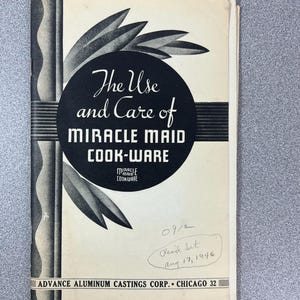 May include: Vintage cookbook cover titled "The Use and Care of Miracle Maid Cook-Ware." The cover is cream-colored with black text and graphics, including a circular design and leaf-like shapes. The text "Advance Aluminum Castings Corp. Chicago 32" is at the bottom.