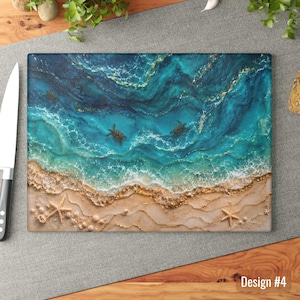 May include: A rectangular cutting board featuring an aerial view of a beach scene with two sea turtles swimming in turquoise and deep blue ocean water. The sandy shore is decorated with gold accents and two starfish, labeled as Design #4.