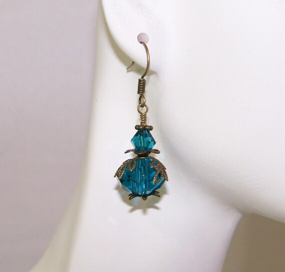Items similar to Blue Zircon dangle earrings, antique brass faceted