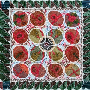May include: A square textile piece featuring a grid of twelve circular motifs in shades of red, brown, and green, overlaid with intricate white line work. A central dark flower-like shape sits amidst the circles, framed by a green leaf border.