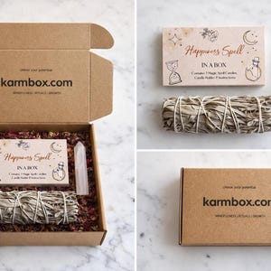 May include: A kraft paper box labeled karmbox.com, open to reveal a Happiness Spell kit. The kit includes a bundle of sage, a crystal, and a card with illustrations and text. The box is filled with dried flowers.