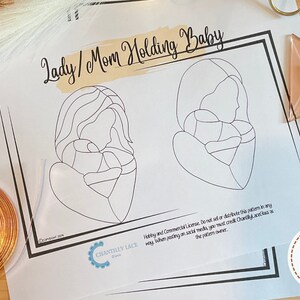 May include: A printable pattern for a stained glass craft project depicting a woman holding a baby. The pattern is titled "Lady/Mom Holding Baby".