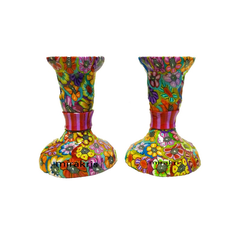 colorful Handmade tall metal Shabbat candlesticks decorated with polymer clay the flowers on this pair of candlesticks are  made one by one using the Millefiori technique in the middle there is pink colors stripes  
size is 3 inches tall