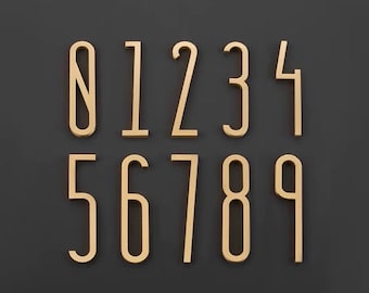 Könnte beinhalten: Goldfarbene Hausnummern aus Metall von 0 bis 9, angeordnet auf einem dunkelgrauen Hintergrund. Die Zahlen haben ein modernes, minimalistisches Design mit einer leicht abgerundeten Schriftart. Jede Zahl ist gut sichtbar.