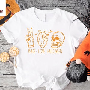 a white t - shirt with a halloween design on it