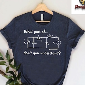 May include: A navy blue t-shirt with a white graphic of a circuit diagram and the text "What part of... don't you understand?"