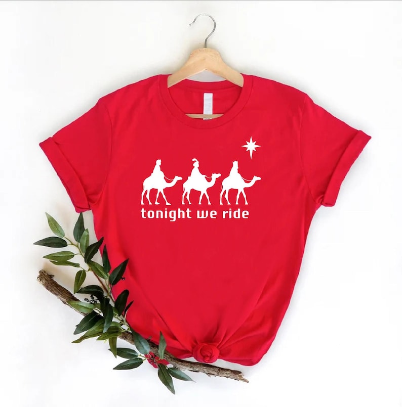 a red t - shirt that says tonight we ride