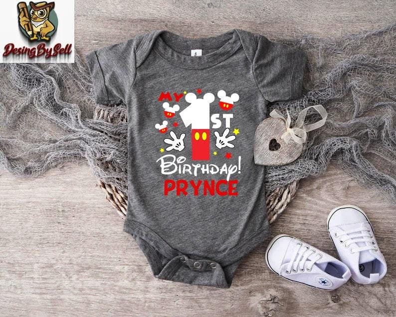 a baby bodysuit with a mickey mouse design on it