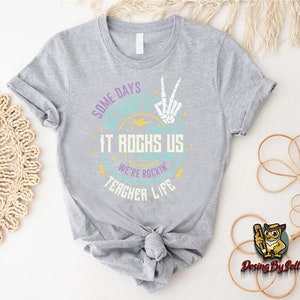 a t - shirt that says one day it rocks us and another life