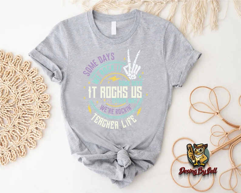 a t - shirt that says one day it rocks us and another life