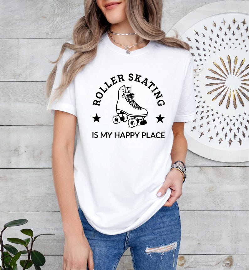 May include: White t-shirt with a black graphic of a roller skate and the text "ROLLER SKATING IS MY HAPPY PLACE". The shirt is made of a soft material and is suitable for casual wear.