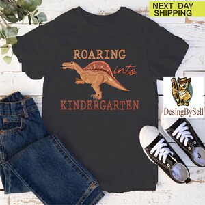 a t - shirt that says roaring into a kind of kind of dinosaur