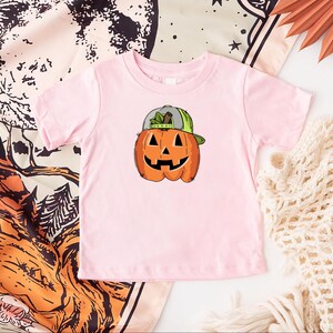 a pink shirt with a pumpkin on it