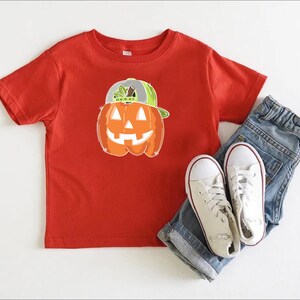 a pair of jeans and a t - shirt with a pumpkin on it