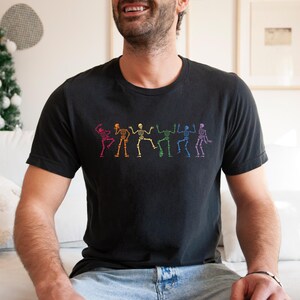 a man sitting on a couch wearing a black shirt