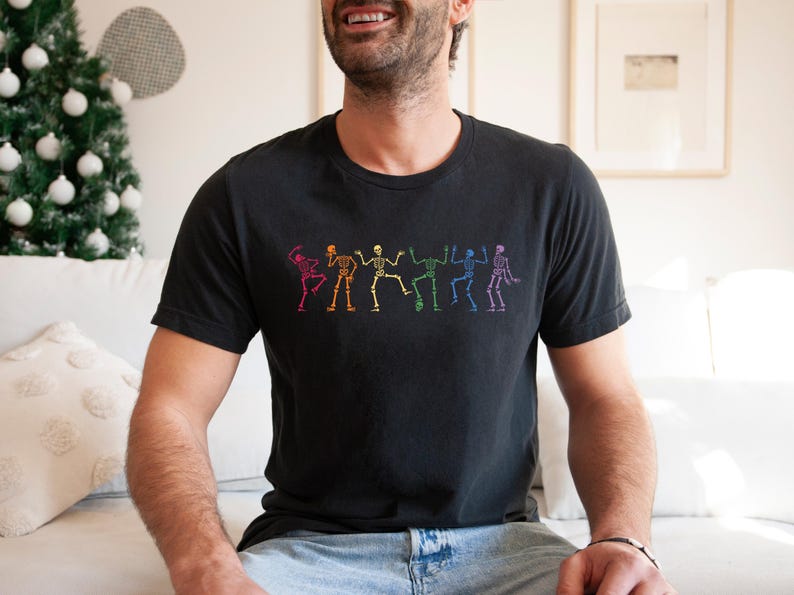a man sitting on a couch wearing a black shirt