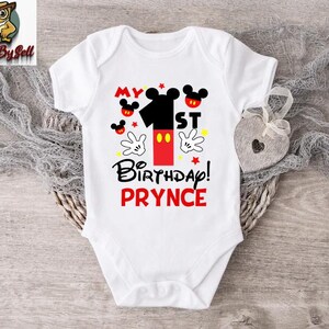 a white bodysuit with a mickey mouse design on it