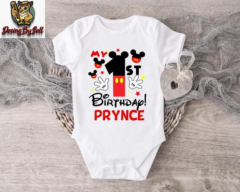 a white bodysuit with a mickey mouse design on it