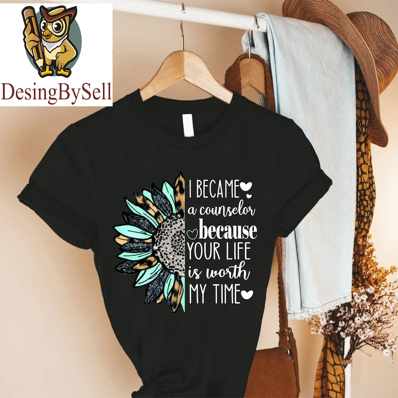 a black t - shirt with a design of a sunflower