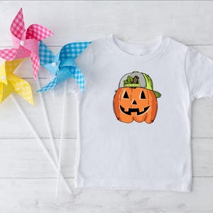 a white t - shirt with a pumpkin on it