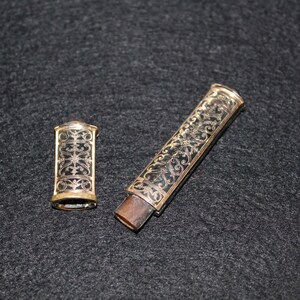May include: Two antique, gold-trimmed, black and gold, decorative, ornate, metal cases with floral designs.