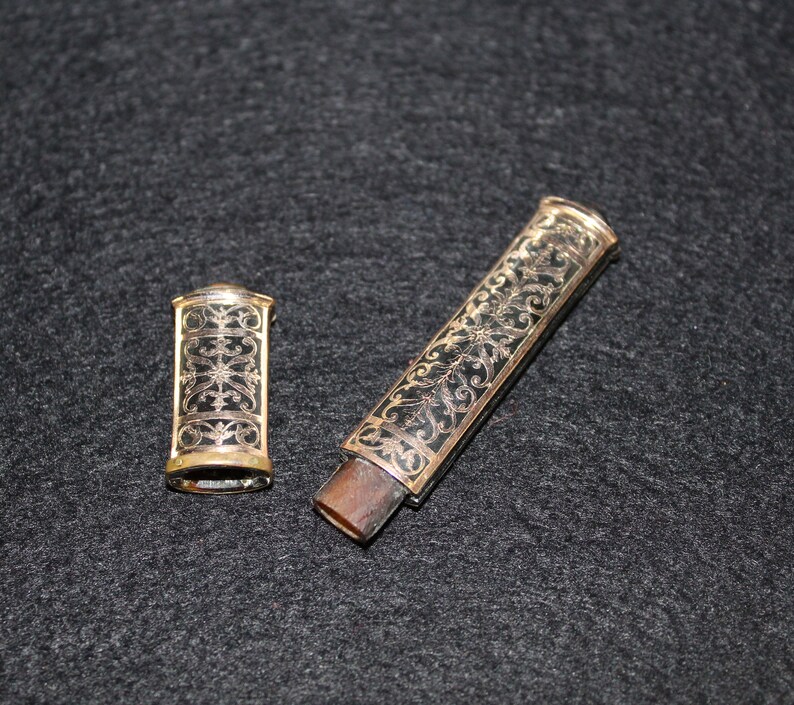 May include: Two antique, gold-trimmed, black and gold, decorative, ornate, metal cases with floral designs.
