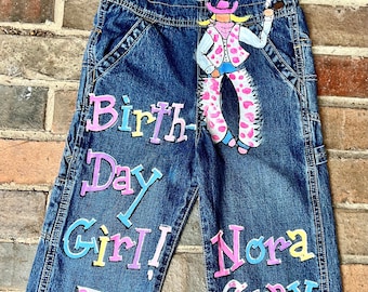 Custom Overalls Cowgirl  Theme Birthday Denim for Little Girls Featuring hand painted rodeo design, lasso, name and age in pink and pastels