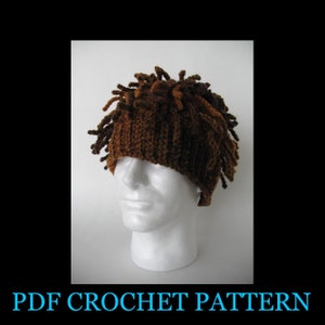 May include: A brown and tan crocheted hat with long strands of yarn hanging down from the top. The hat is on a white mannequin head.