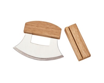 May include: A curved stainless steel mezzaluna knife with a light brown wooden handle, accompanied by a separate rectangular wooden storage block featuring a vertical slot for the blade to rest securely when not in use.