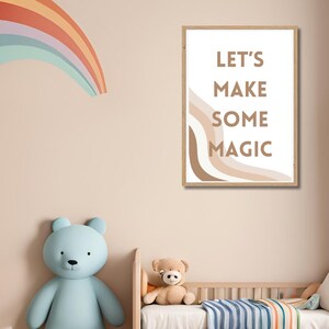 May include: A nursery room with a rainbow wall decal, a wooden crib with a striped blanket, and a framed print with the text "Let's Make Some Magic".