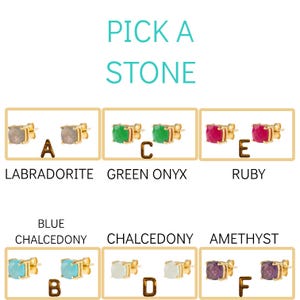 May include: Six pairs of gold stud earrings with different colored gemstones. The stones are labradorite, blue chalcedony, green onyx, white chalcedony, ruby, and amethyst. The earrings are labeled with letters A through F.