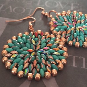 May include: A pair of turquoise and copper beaded earrings with a circular design. The earrings are made with small, iridescent beads and have a copper wire hook.