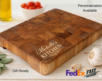May include: A wooden butcher block cutting board with a personalized inscription that reads "Michelle's KITCHEN". The board is made of various wood pieces and has a natural wood grain pattern. Garlic and tomatoes are in the background. The board is ideal for food preparation.