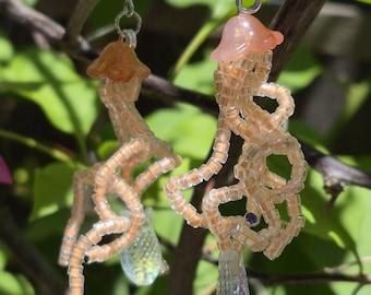 Beaded glow in the dark orange jellyfish dangle earrings UV reactive handmade gift for girlfriend gift for raver