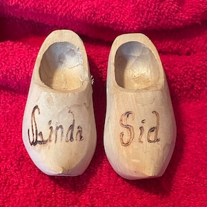 May include: Two wooden clogs with the names "Linda" and "Sid" burned into the wood.