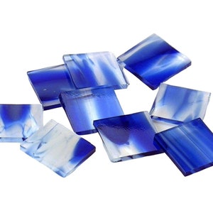 May include: A collection of blue and white glass mosaic tiles. The tiles are square and have a marbled effect.