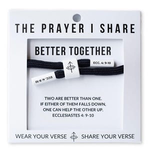 May include: A black rope bracelet with white accents, displayed on a white card. The card reads "THE PRAYER I SHARE" and "BETTER TOGETHER." Text includes "ECC. 4:9-10" and a quote from Ecclesiastes. The bracelet is a faith-based accessory.