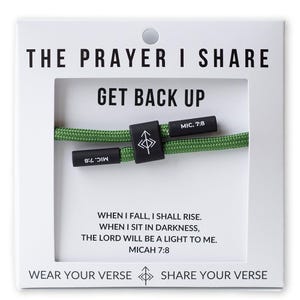 May include: A green rope bracelet with black clasps, displayed on a white card. The card reads "THE PRAYER I SHARE" and "GET BACK UP." Text on the card includes "MIC. 7:8" and a verse from Micah 7:8. The bracelet is a wearable item.