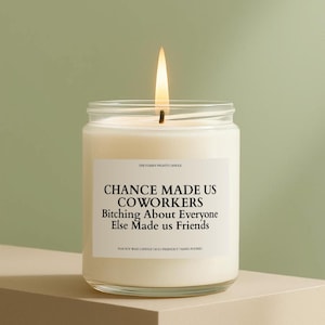 May include: A lit soy wax candle in a clear glass jar. The label reads "CHANCE MADE US COWORKERS Bitching About Everyone Else Made us Friends." The candle is hand-poured and eco-friendly.
